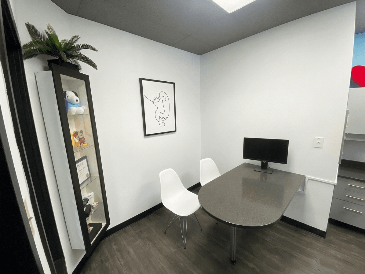 The private consultation room, with a desk, two chairs and a chairside monitor