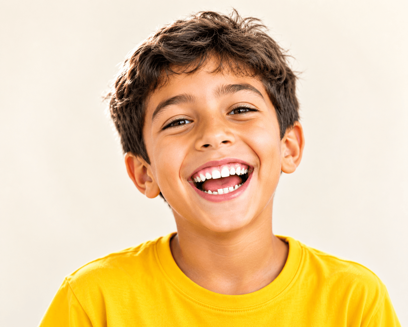 A young child laughing, showing a mix of baby and adult teeth
