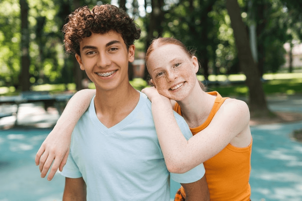 Two teenagers smiling together outdoors